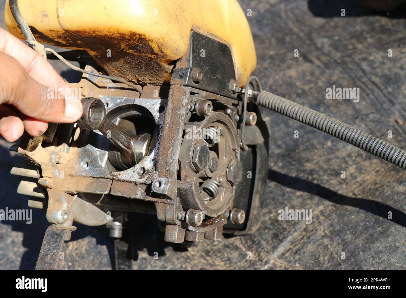 Connecting rod from a small petrol engine used on brush cutters. Repairing gasoline powered grass cutting machine Stock Photo