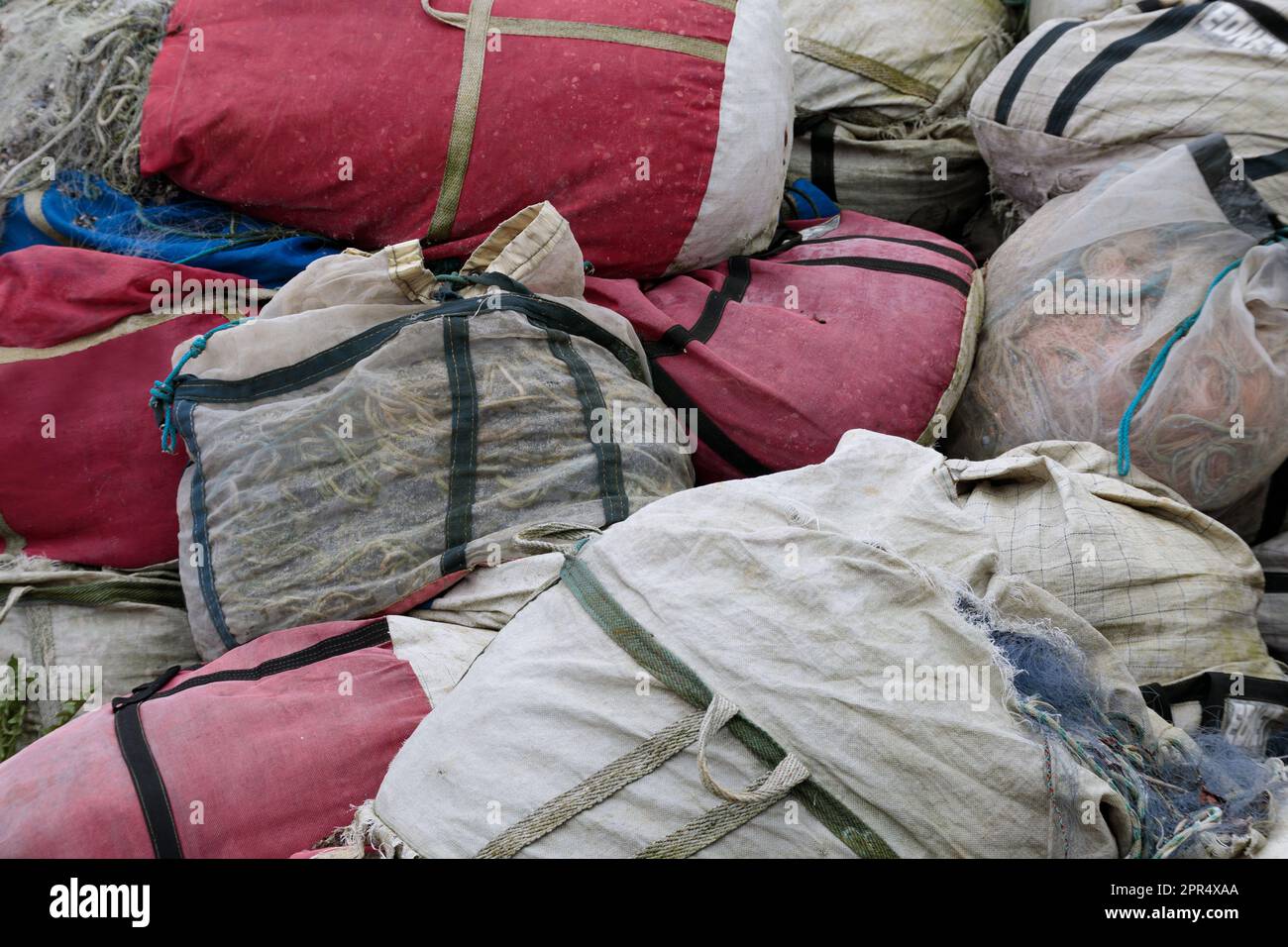 Retro fishing nets in bags, closeup. A pile of old fishing net Stock
