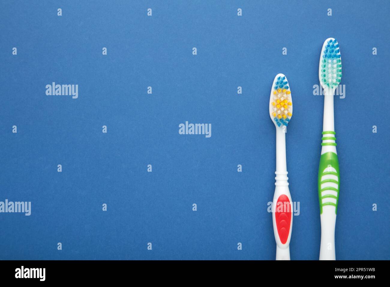 Two toothbrushes on blue background with copy space. Top view Stock ...