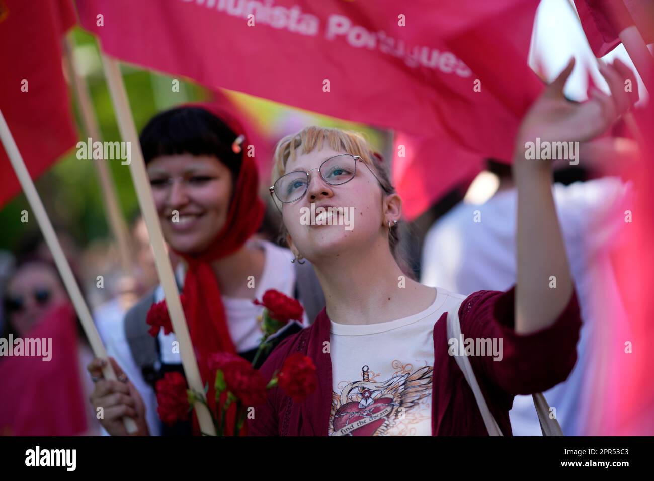 Members of the Portuguese Communist Party Youth carry flags and