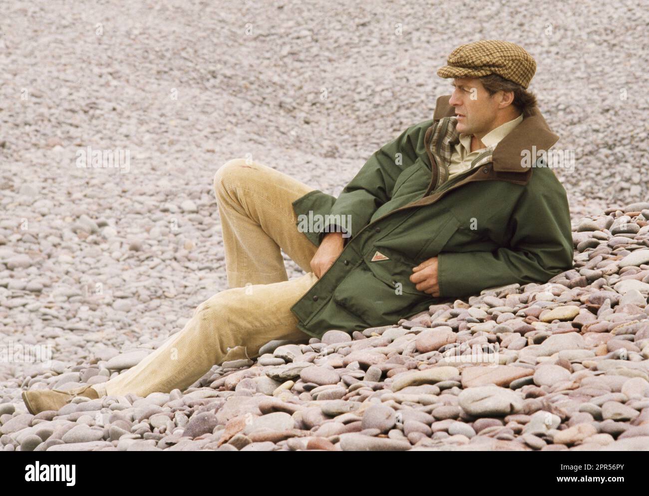 Sir Ranulph Fiennes photographed laying on a pebble beach in North ...