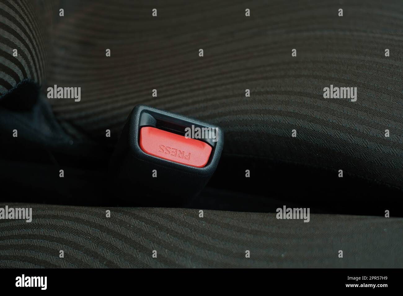 The red seat belt slot with text "Press" inside a car Stock Photo Alamy