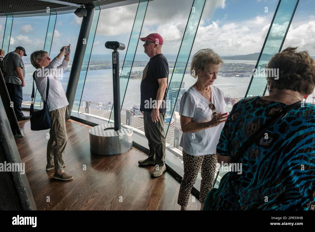 Tourists taking photographs of the view from the observation deck, Sky Tower, Auckland, North Island, New Zealand Stock Photo