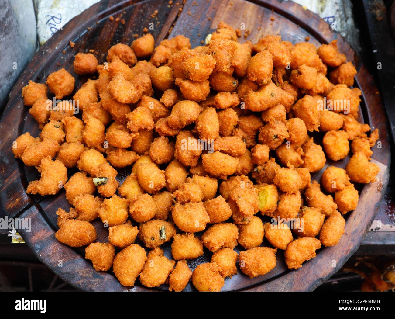 Tasty Pakora aka Pakoda. Indian Deep Fried Street Food on Sale. Stock Photo