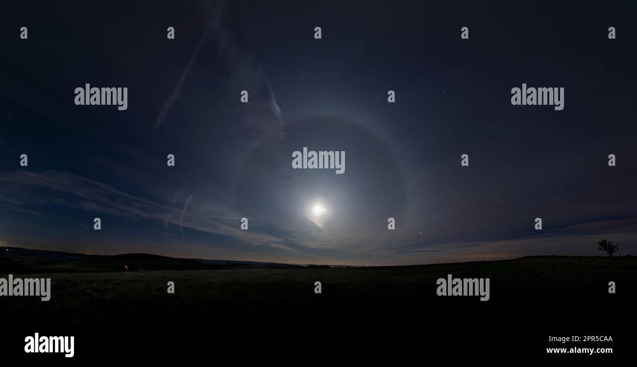 Halo around the moon from a night walk in the Peak District. A 22° halo as the ice crystals in Earth's atmosphere refract and reflect the moonlight Stock Photo