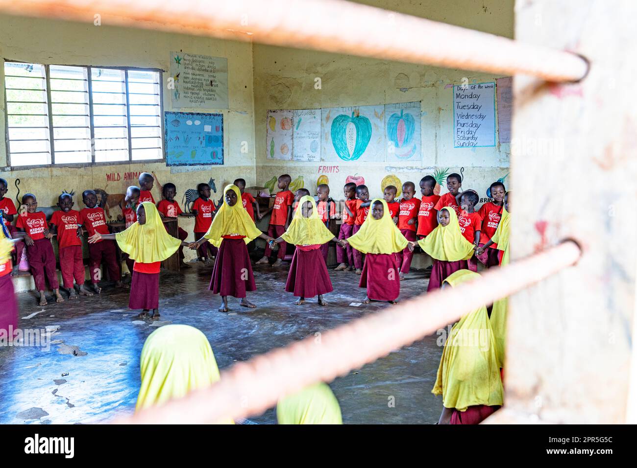 Little boys and girls attending a lesson in a classroom of a primary school, Kidoti, Zanzibar, Tanzania Stock Photo
