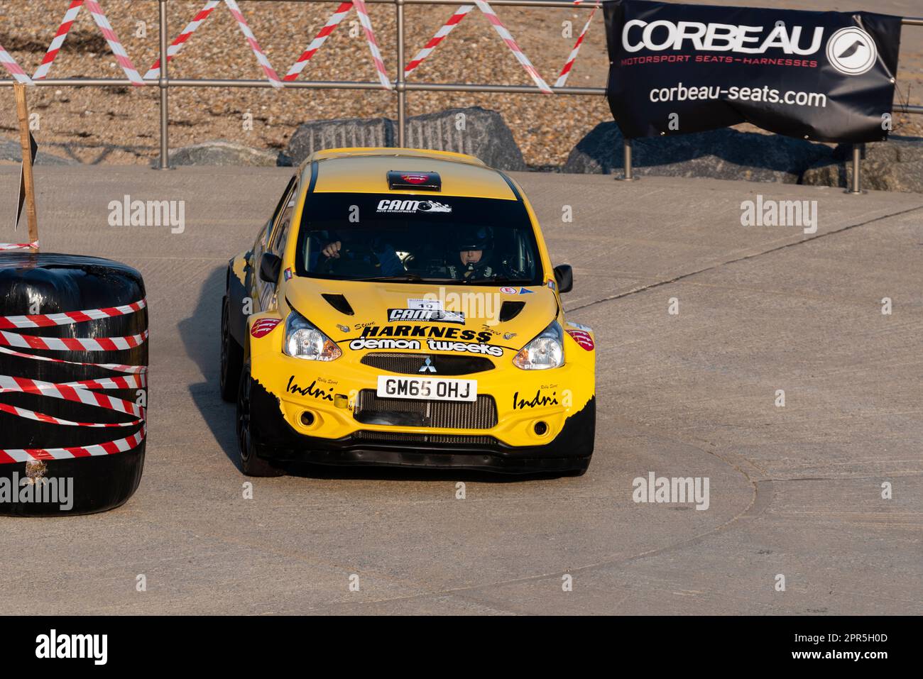 John Indri driving a Mitsubishi Mirage R5+ competing in Corbeau Seats rally on the seafront at Clacton on Sea, Essex, UK. Co driver Claire Williams Stock Photo