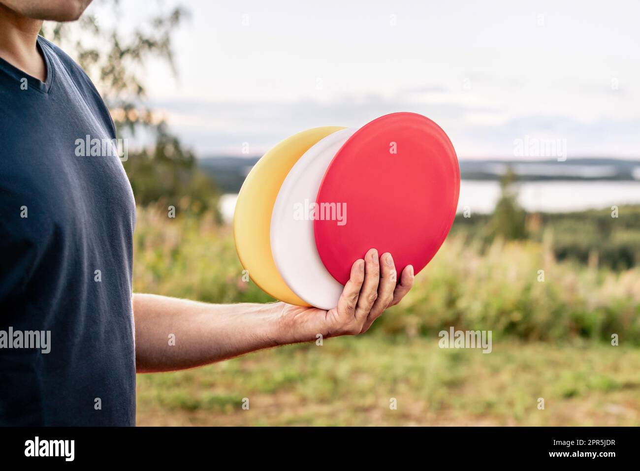 Disc golf. Discgolf or ultimate equipment. Park course and nature landscape. Throwing to target, goal or basket. Sport tournament. Stock Photo