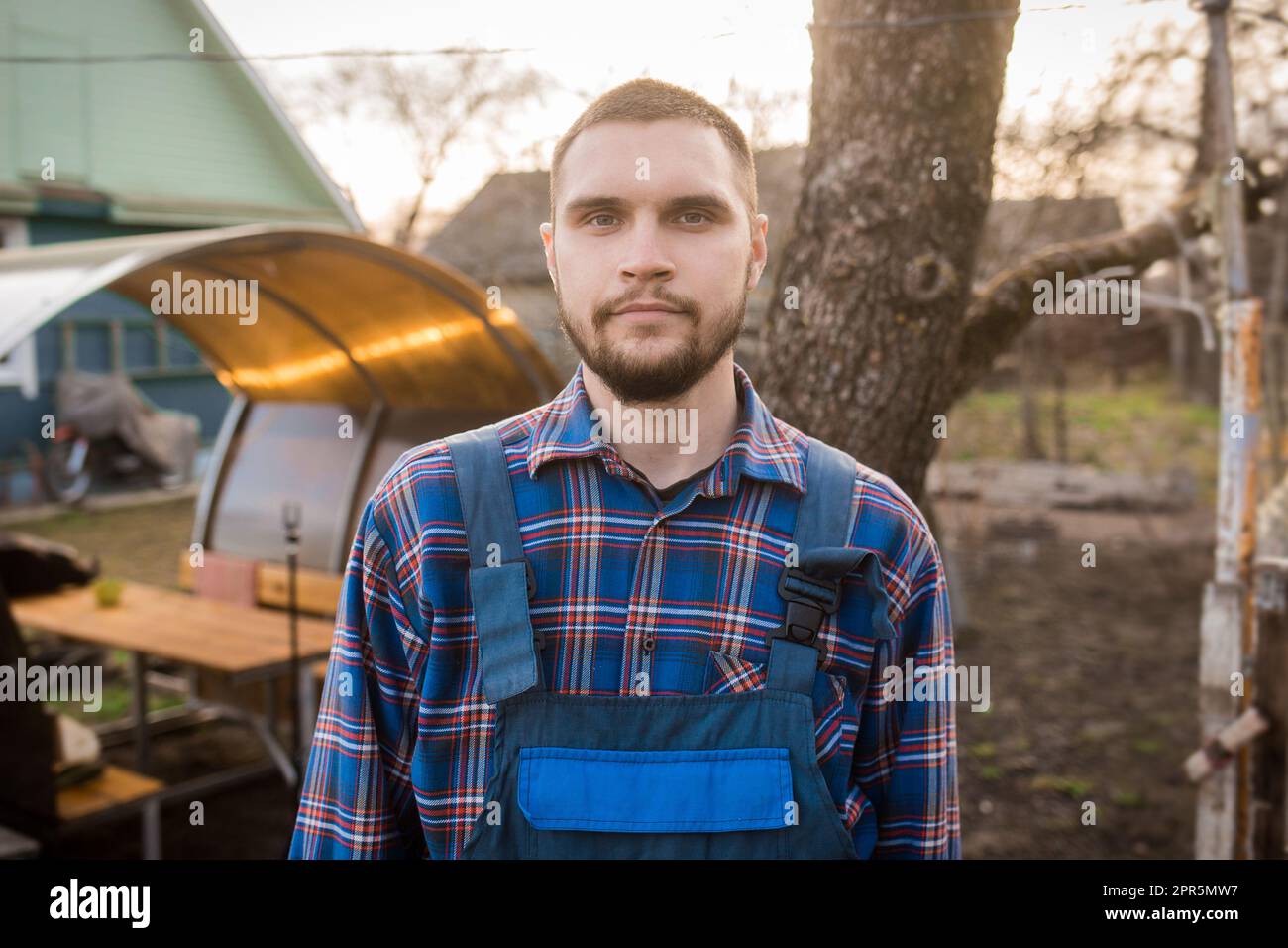 A farmer man of European appearance rural portrait with a beard, a ...