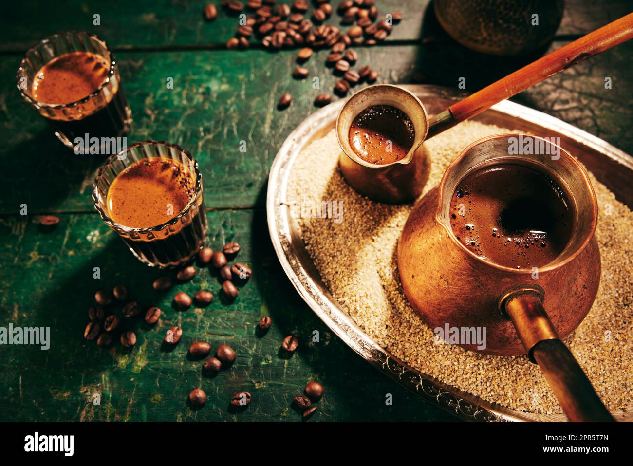 https://c8.alamy.com/comp/2PR5T7N/freshly-brewed-turkish-coffee-on-sand-2PR5T7N.jpg