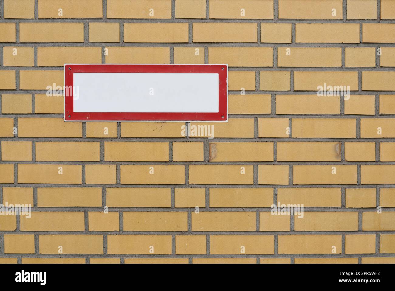 blank white sign with text free space on brick wall Stock Photo