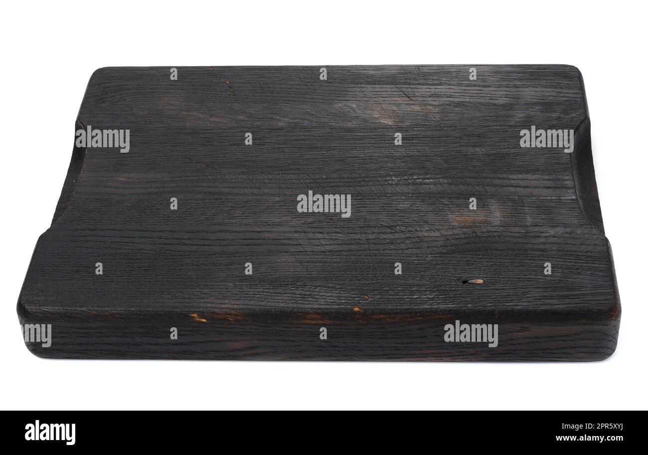 empty rectangular black wooden cutting kitchen board on a white isolated background Stock Photo