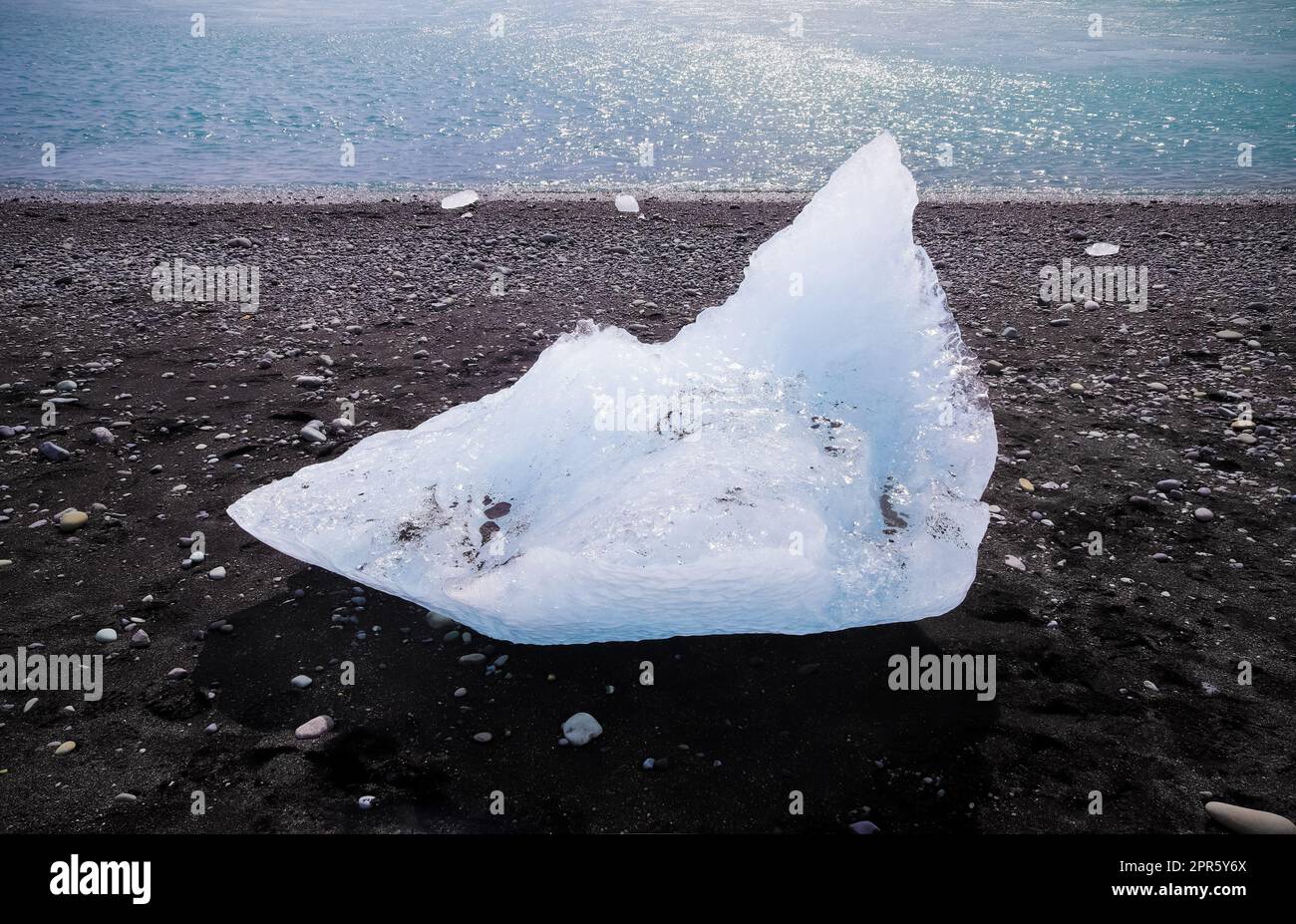 Diamond Beach in Iceland with blue icebergs melting on black sand and
