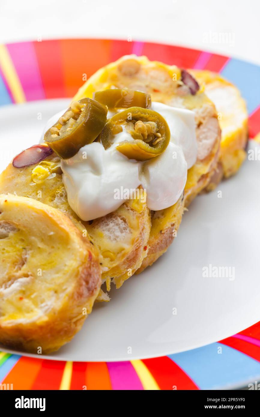 bean dumplings with sour cream and jalapenos Stock Photo