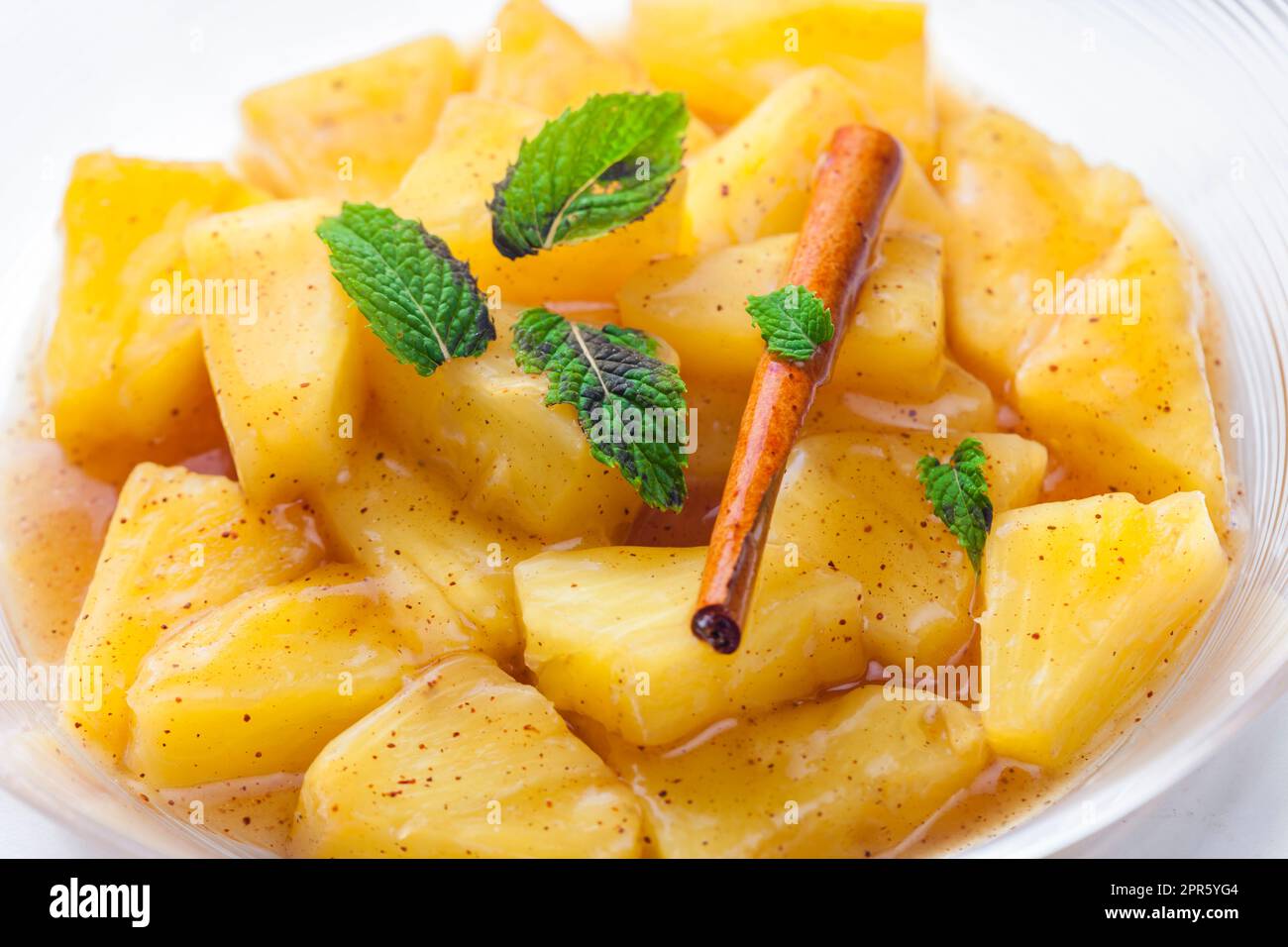pineapple compote with cinnamon and mint Stock Photo - Alamy