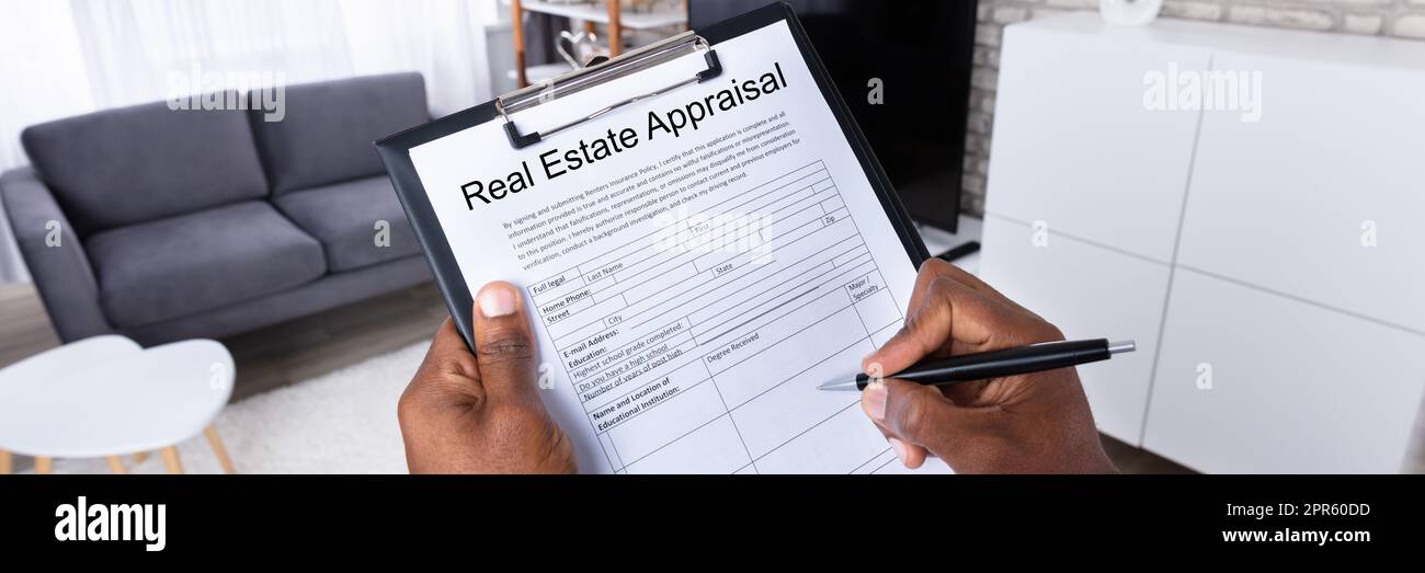 Man Filling Real Estate Appraisal Form Stock Photo