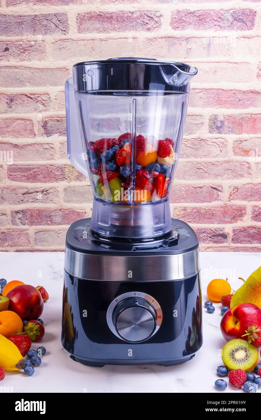 Preparing fresh fruit smoothie in blender Stock Photo Alamy