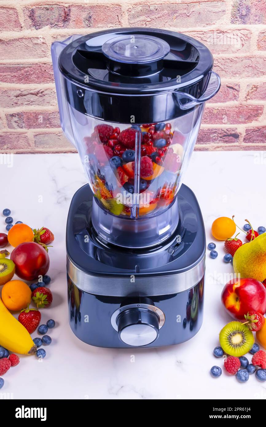 Preparing fresh fruit smoothie in blender Stock Photo Alamy
