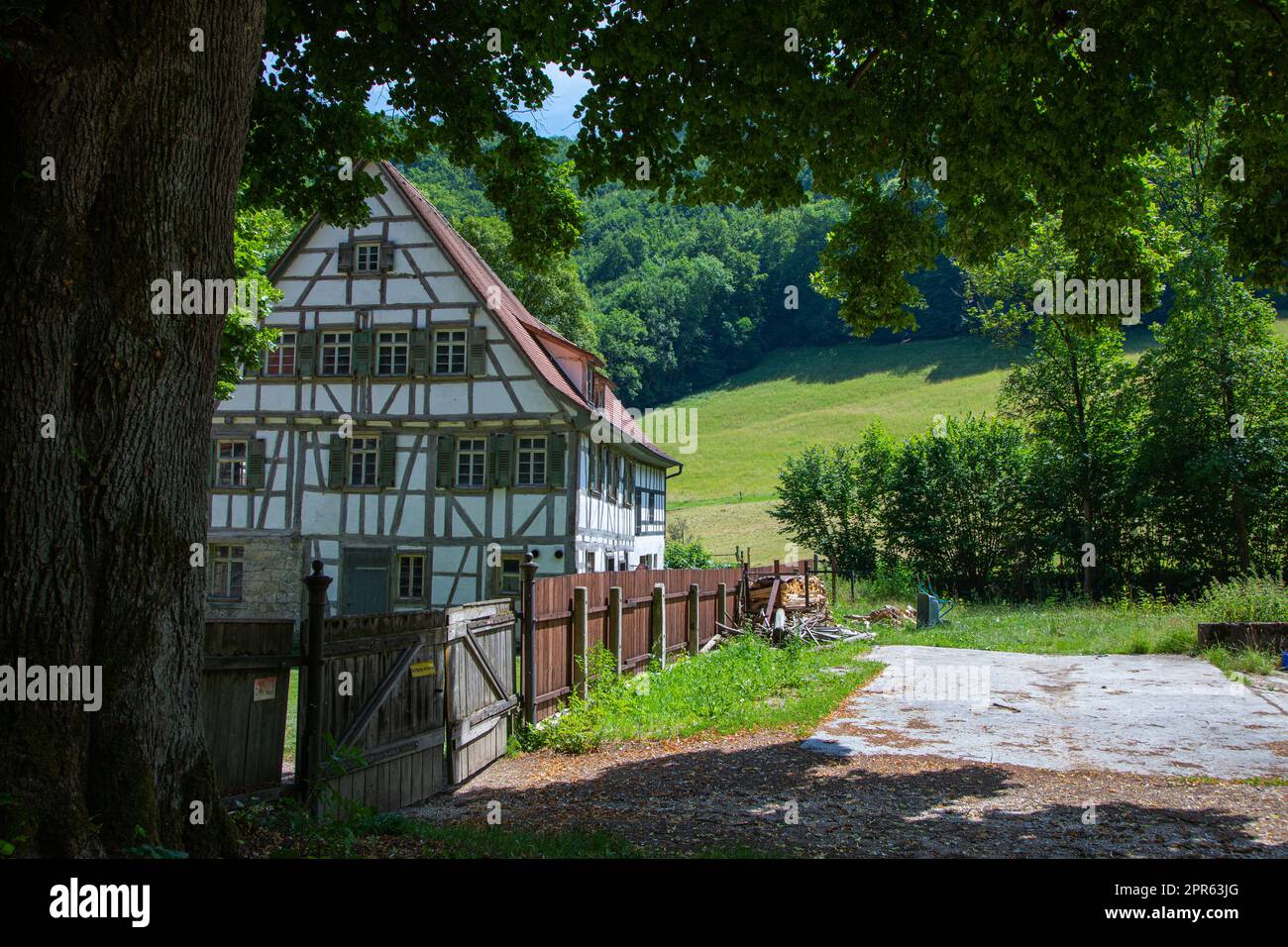 old farm house with tree stem Stock Photo