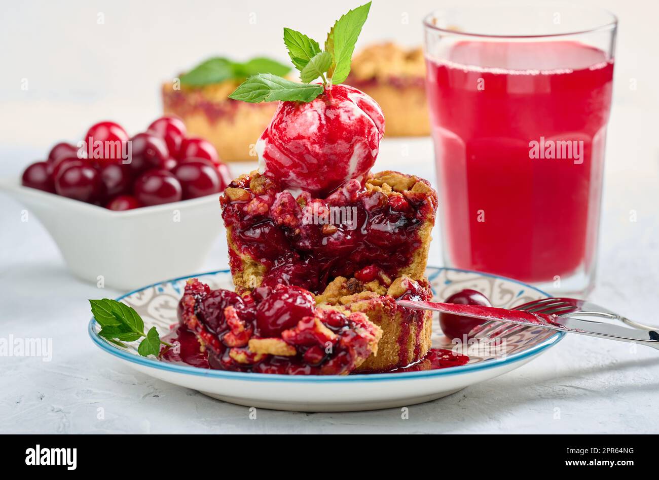 Cherry crumble pie decorated with a scoop of ice cream Stock Photo
