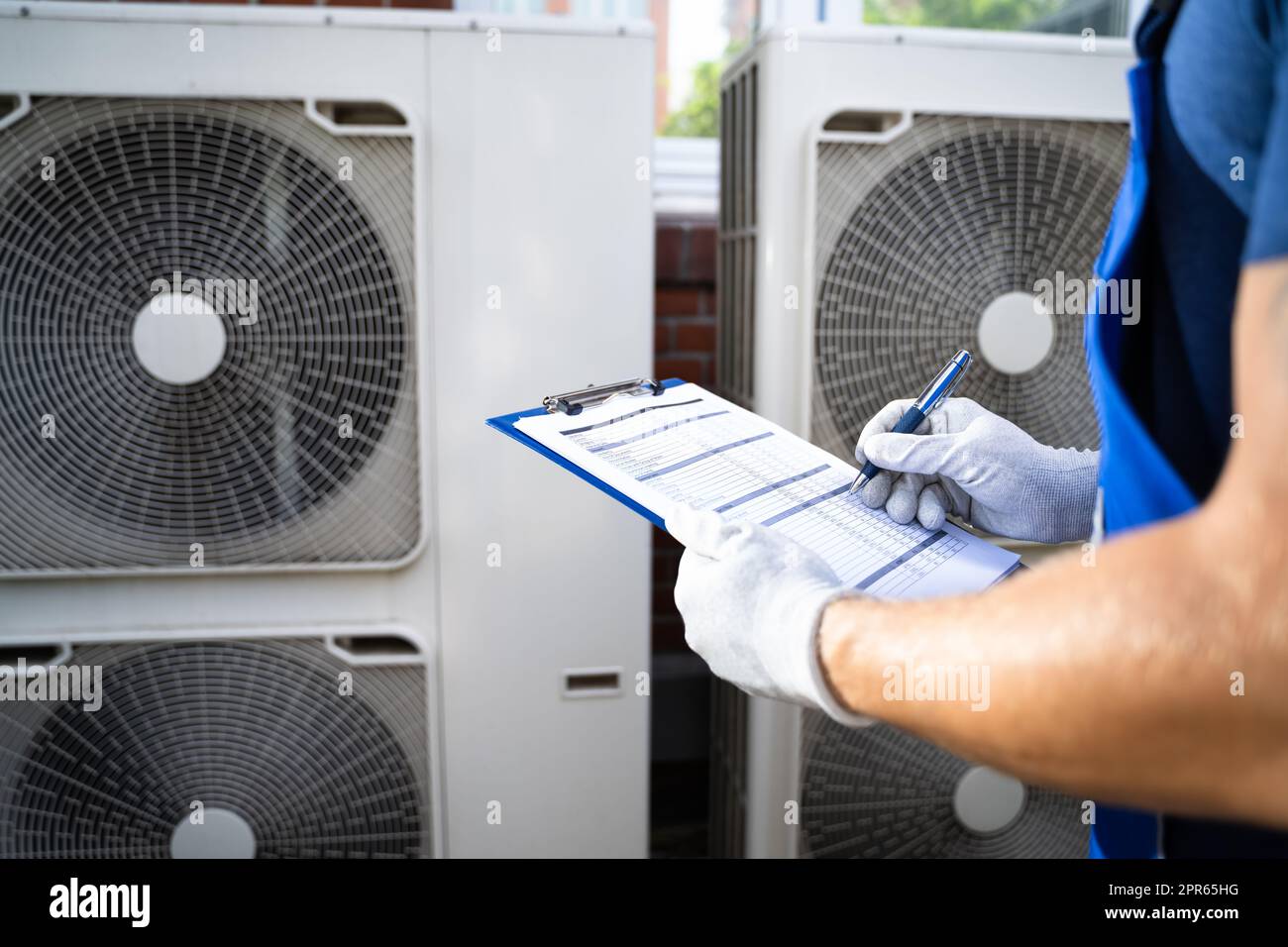 An Electrician Men Checking Air Conditioning Unit Stock Photo