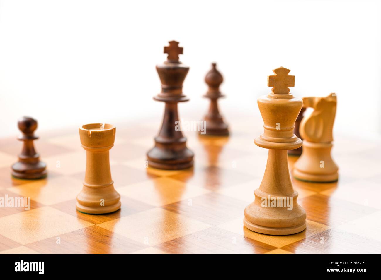 Chess pieces on a chessboard with white background Stock Photo