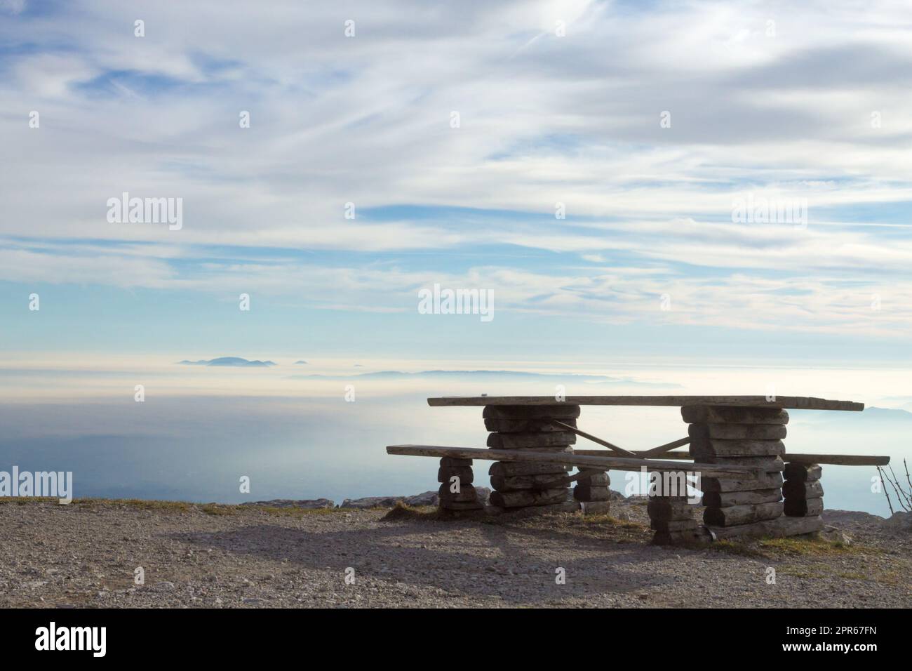 Horizon landscape with clouds and bench in foreground Stock Photo
