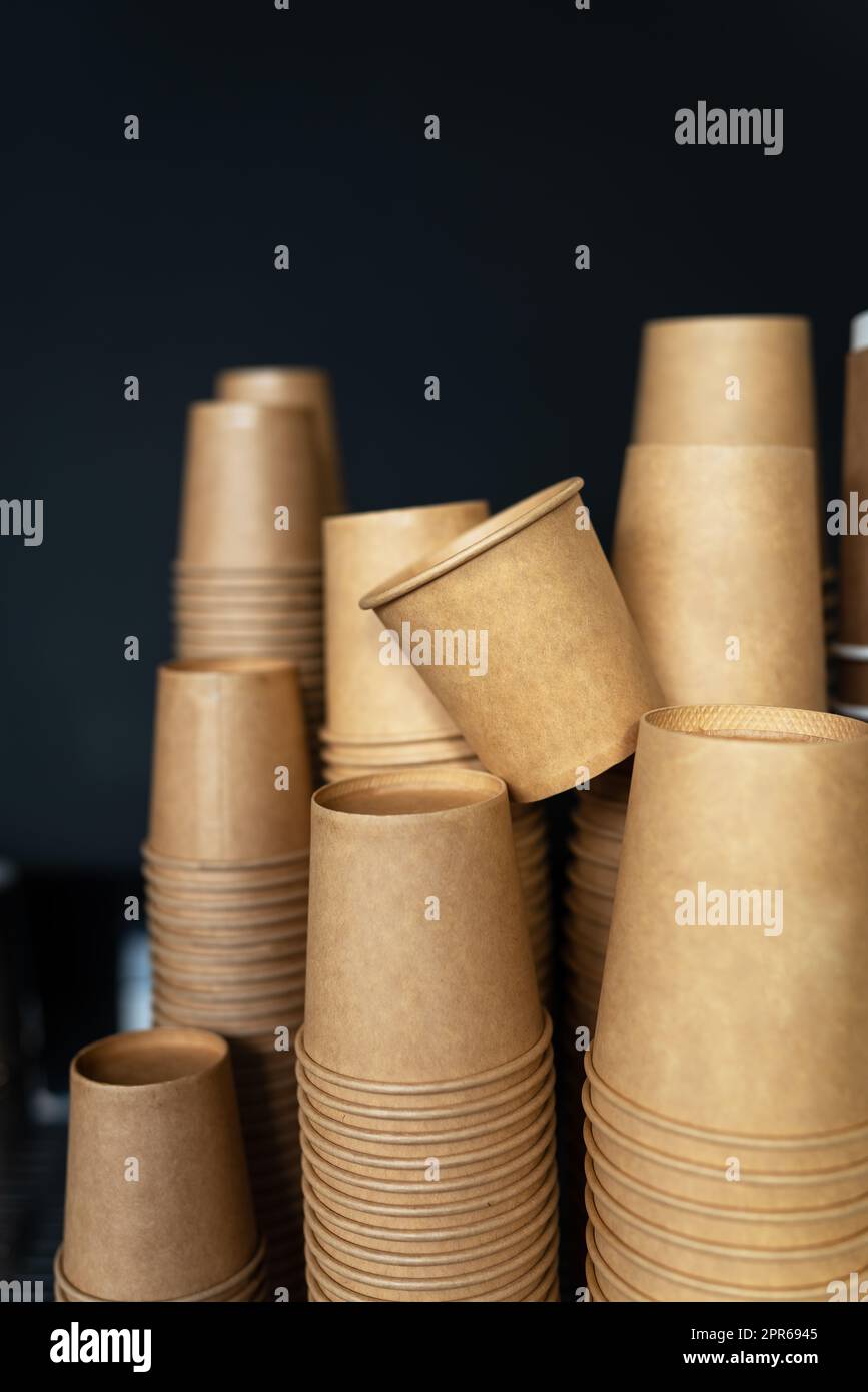 Disposable paper cups on a black background stand in a coffee shop ...