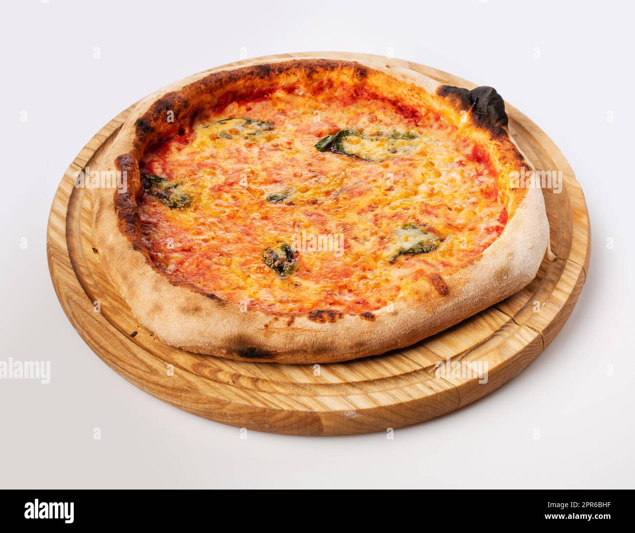 Top view of hot pizza on a wooden stand. Stock Photo