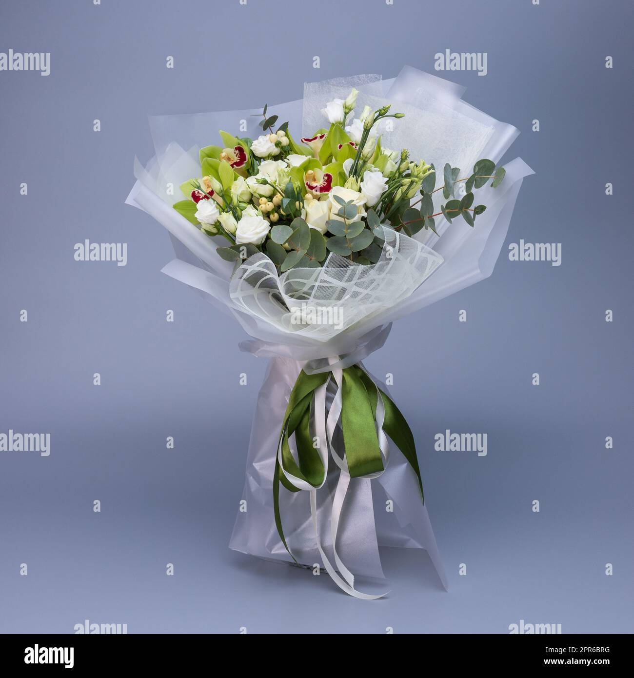 Flower bouquet in light green color, which is wrapped in light floral