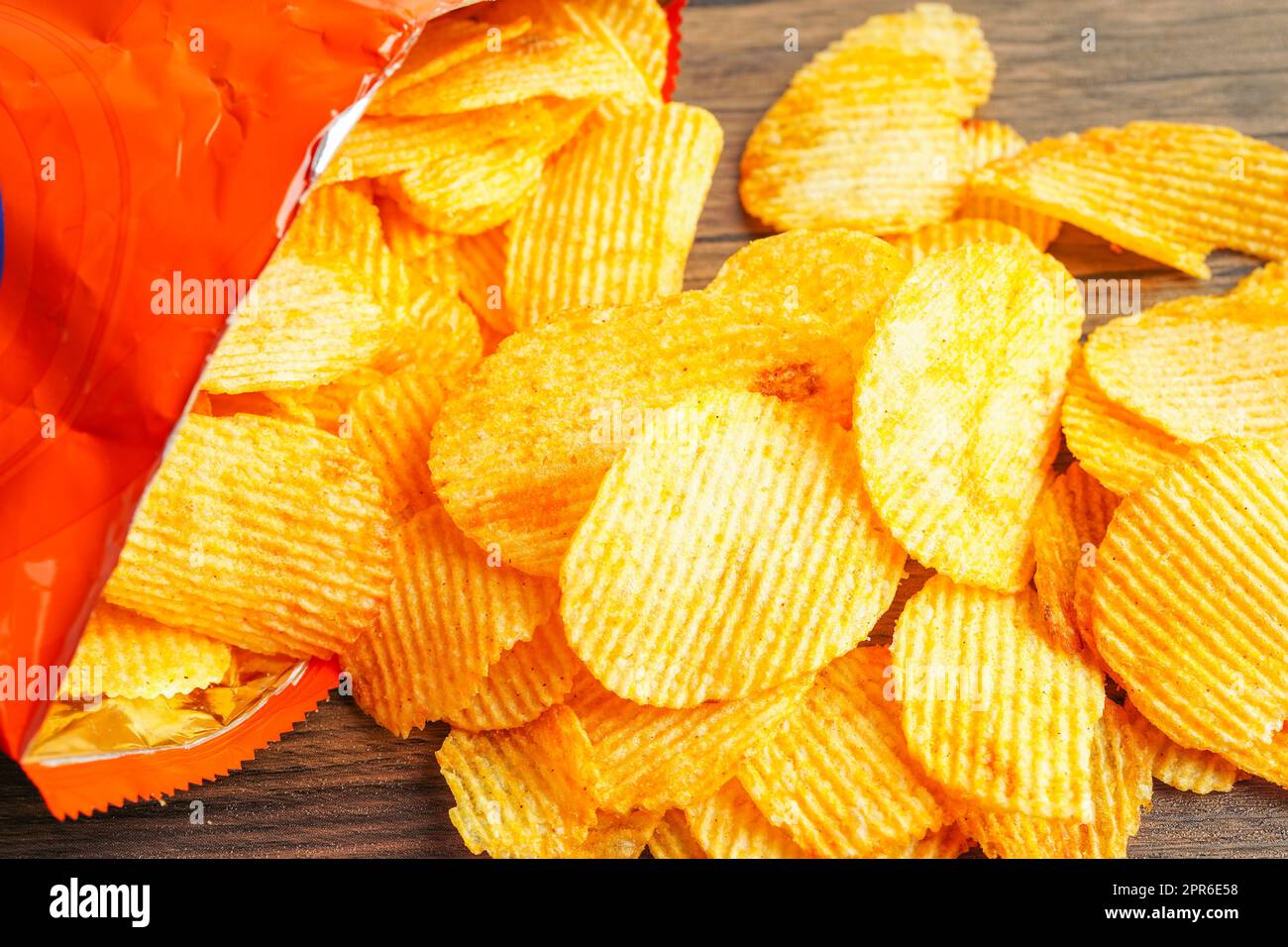 Potato chips in open bag, delicious BBQ seasoning spicy for crips, thin slice deep fried snack fast food. Stock Photo