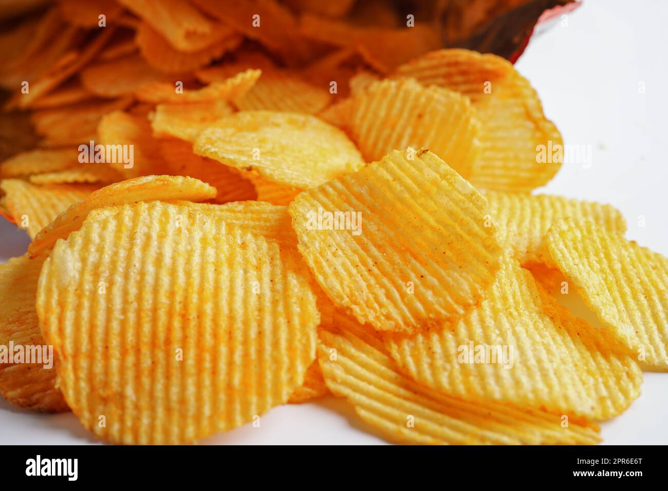 Potato chips in open bag, delicious BBQ seasoning spicy for crips, thin slice deep fried snack fast food. Stock Photo