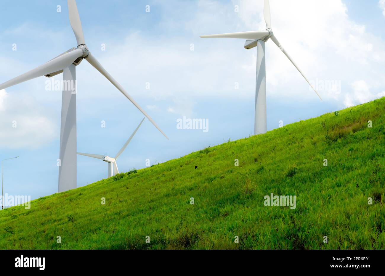Wind energy. Wind power. Sustainable, renewable energy. Wind turbines generate electricity. Windmill farm with blue sky. Renewable resource. Sustainable development. Global energy crisis concept. Stock Photo
