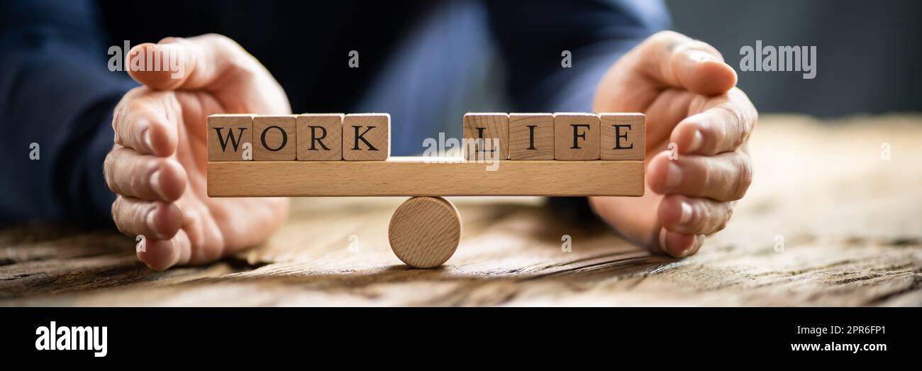Hand Covering Balance Between Life And Work On Seesaw Stock Photo - Alamy