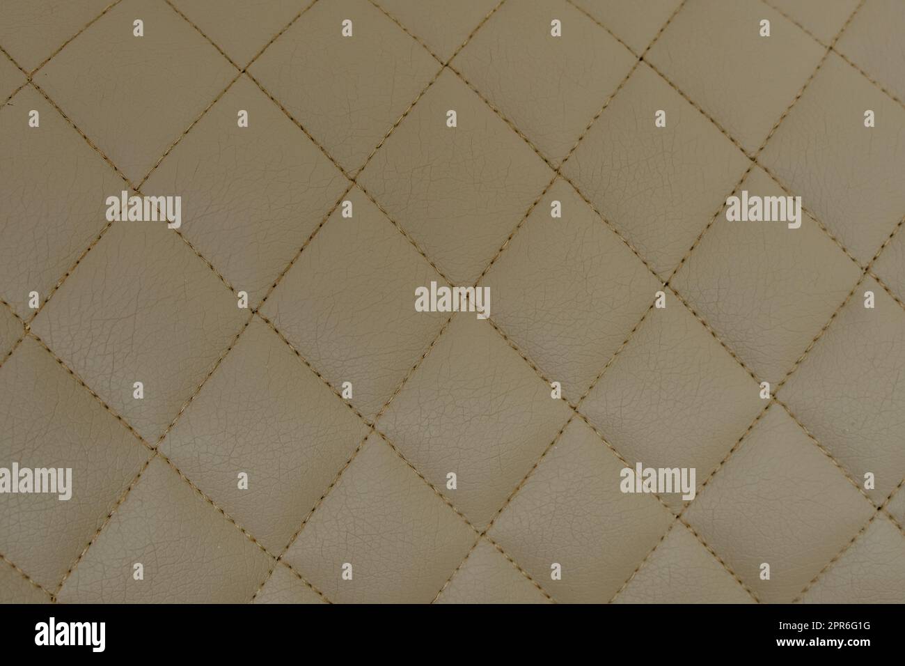 Background of beige leather quilted in the form of rhombuses Stock Photo