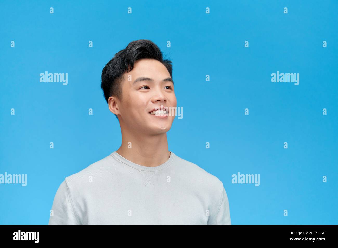 Happy joyful smiling young indian man looking aside up thinking of new good opportunities, Stock Photo