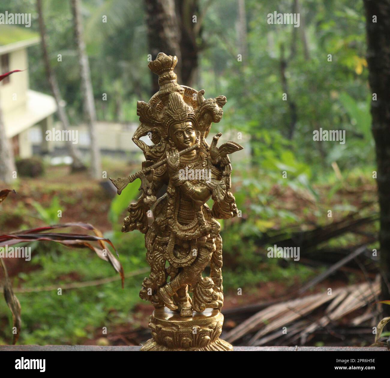 Lord krishna brass idol in golden color Stock Photo