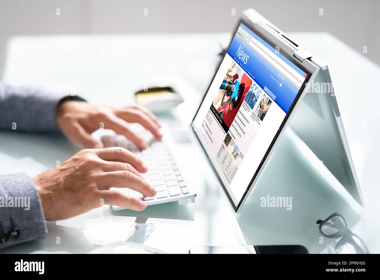 Watching News On Screen. Reading Newspaper Website Stock Photo