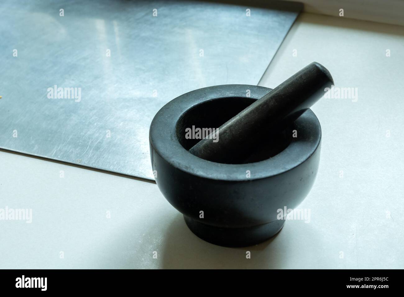 Dark stone kitchen mortar on the countertop Stock Photo