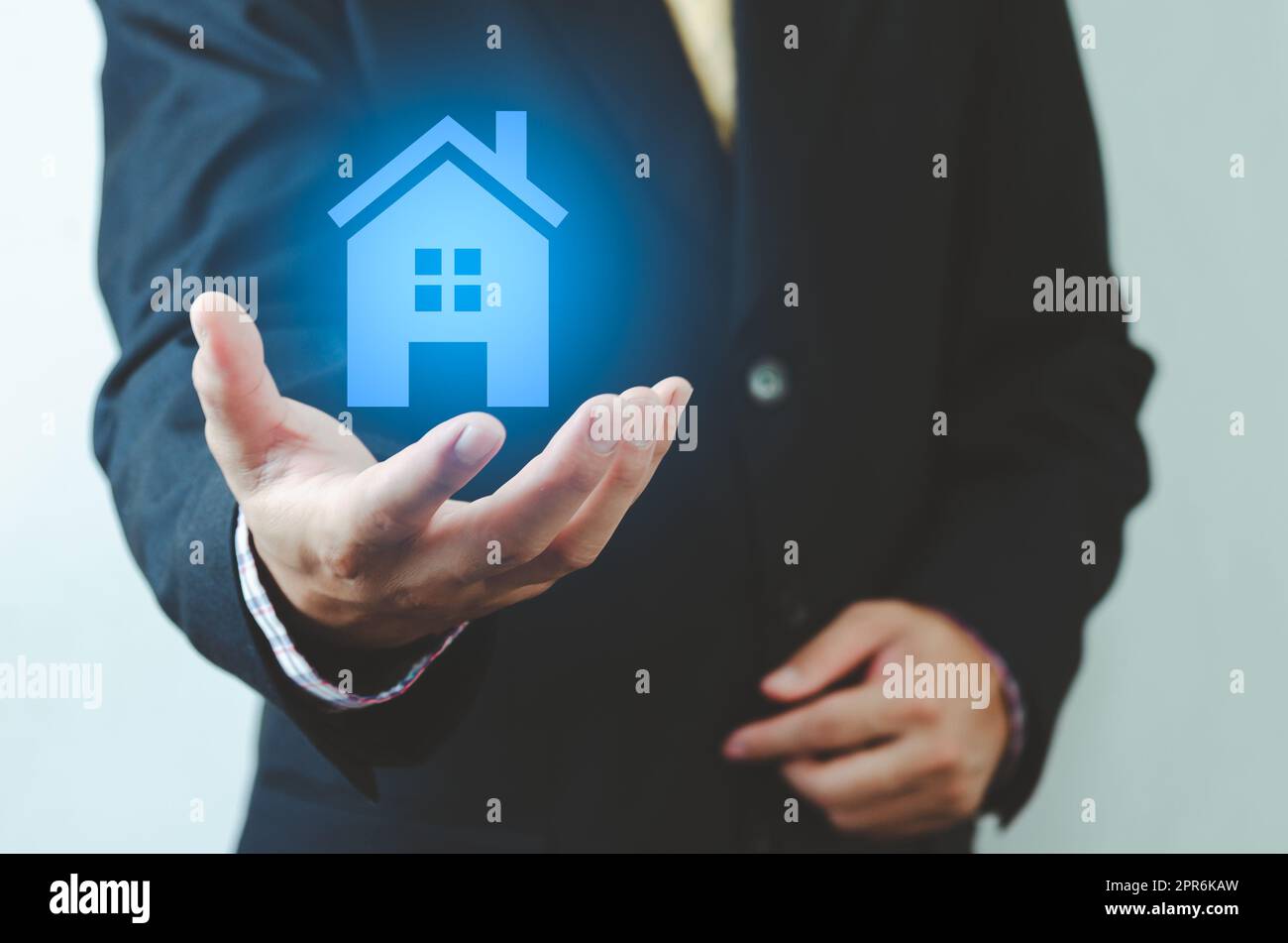 real estate ideas house trading Businessman holding house icon. House on hand. Insurance and safety concept. Symbol of house.. Stock Photo