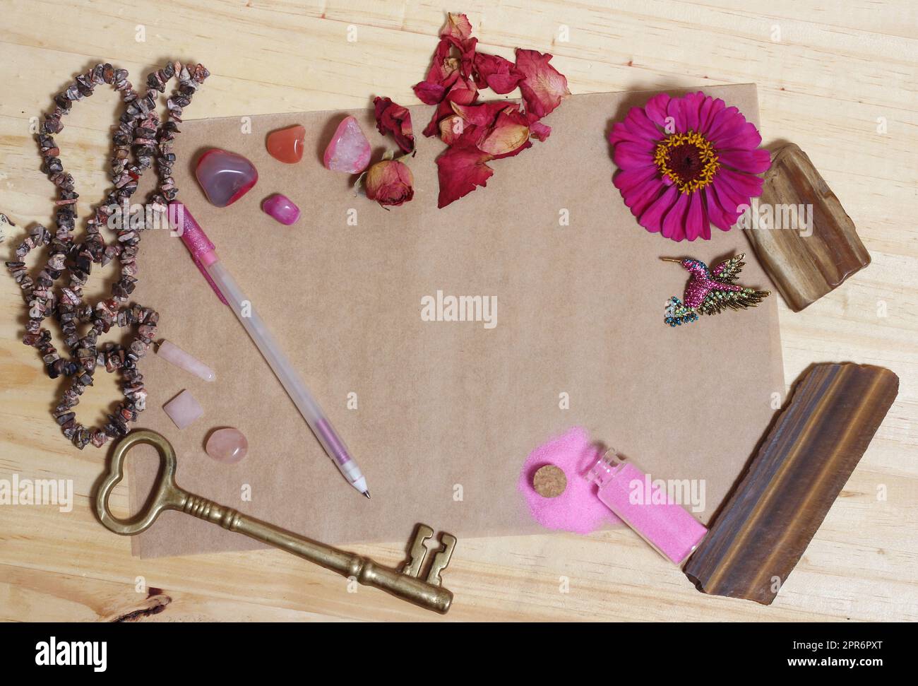 Pink Flower With Pink Stones and Brass Key on old Paper Stock Photo - Alamy