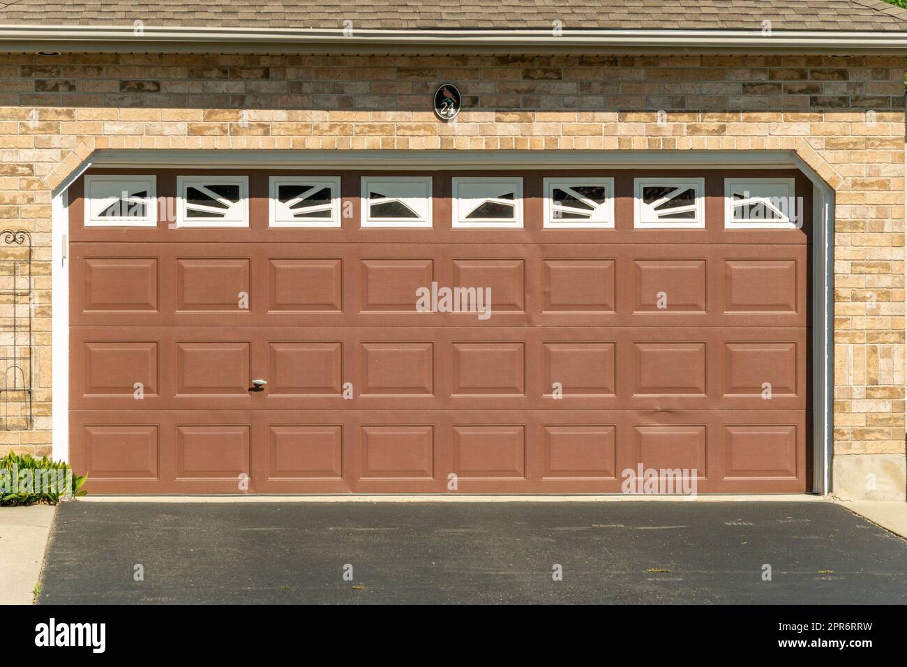Brown garage door with white windows Stock Photo Alamy