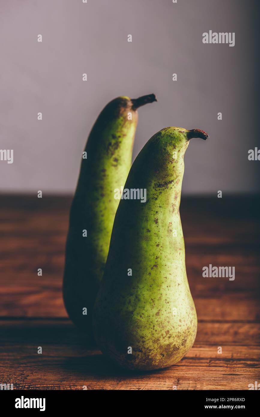 Two Green Pears on Wooden Table Stock Photo