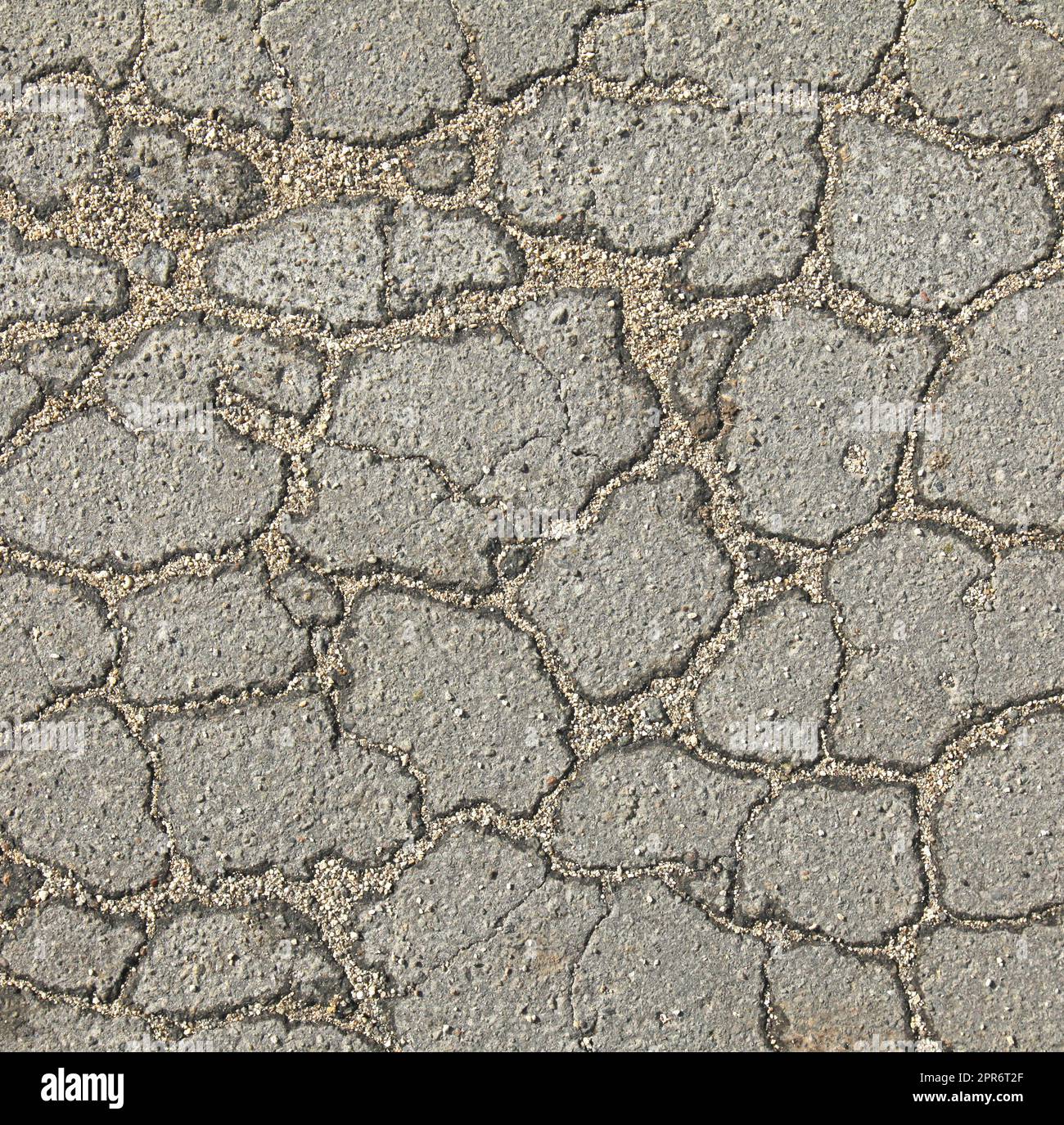 Asphalt surface of the road with a cracks in the middle, background