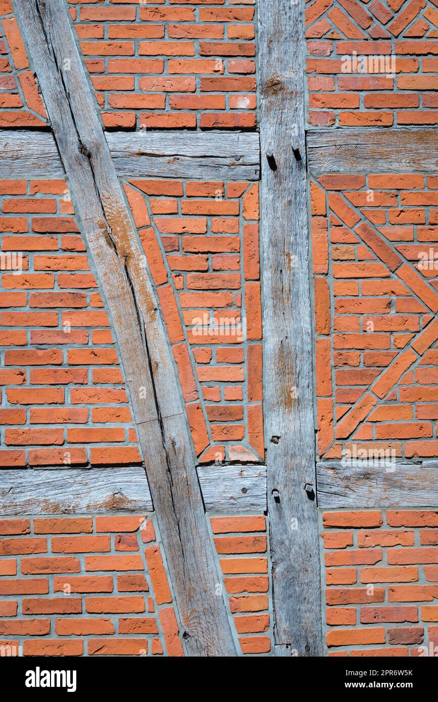 Old wall made of brown half-timbered, bricked with bricks in different shades Stock Photo