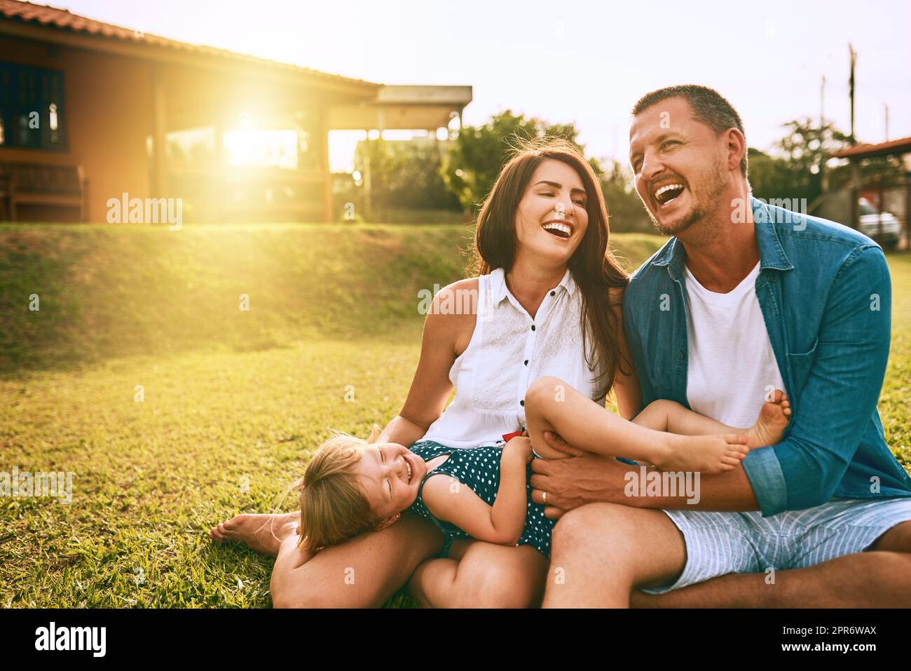 Their family is all about the love. Cropped shot of a young family spending time together outdoors. Stock Photo