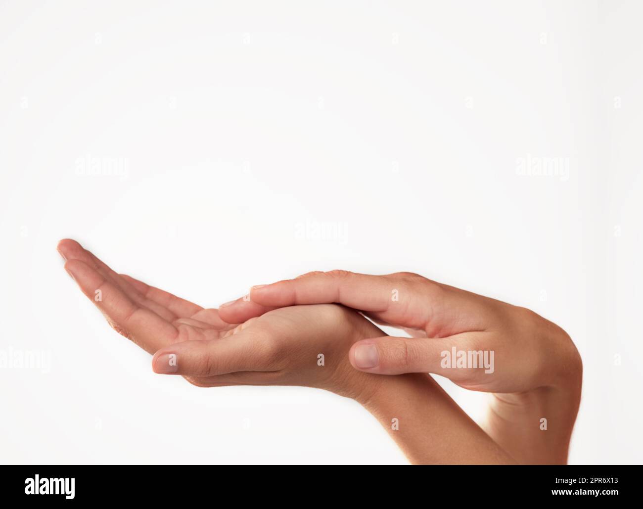 Beauty from fingertip to fingertip. Closeup studio shot of a womans hands. Stock Photo