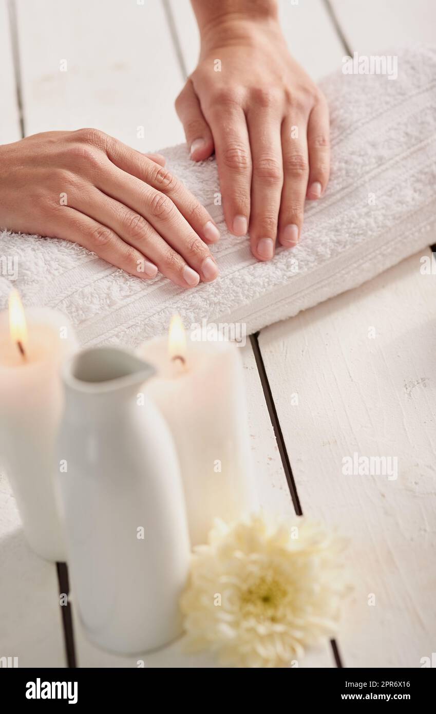 Hands as soft as velour. Cropped shot of a womans hands on a towel at a spa. Stock Photo