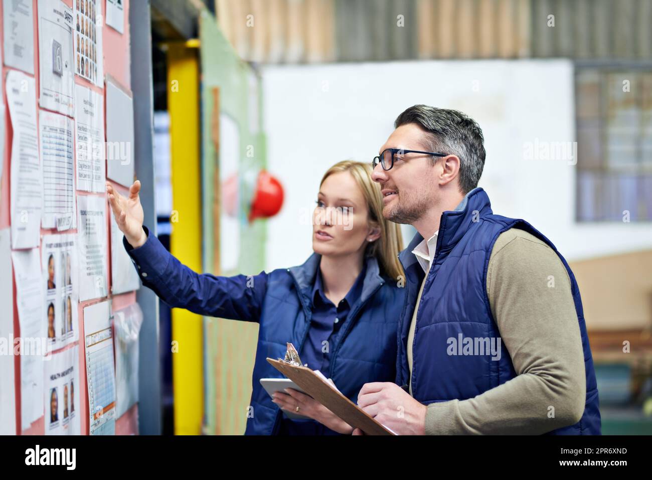 This all needs updating. Cropped shot of a two coworkers managing a warehouse. Stock Photo