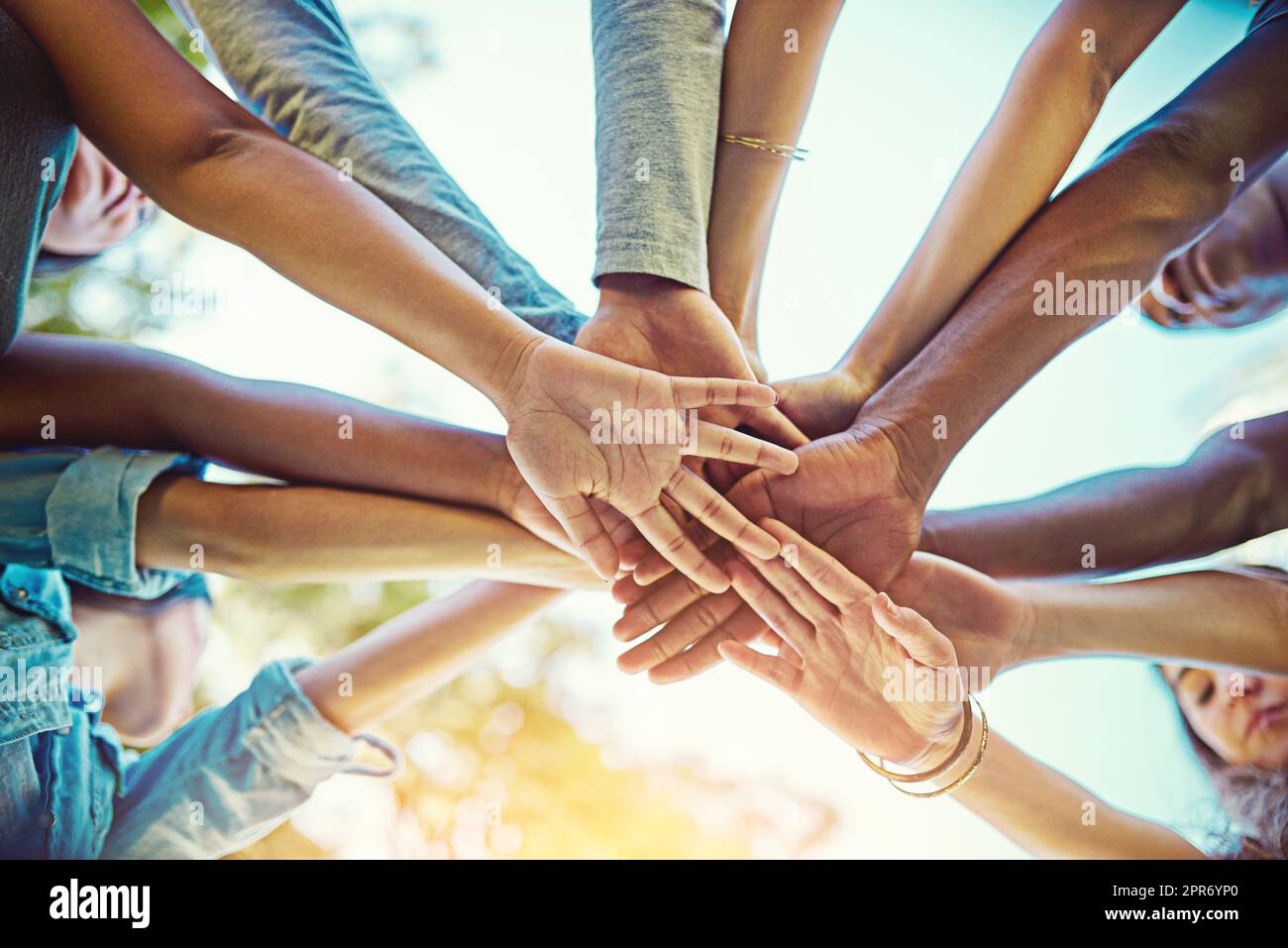 Life is amazing when you have the greatest friends around. Cropped shot of a group of friends with their hands piled on top of each other. Stock Photo